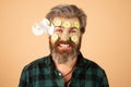 Funny man applied facial masks and cucumbers on face. Funny surprised and crazy comic concept. Facial beauty treatment.
