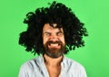 Funny man in black wig. Man with beard and mustache in curly periwig. Bearded hipster in black curly afro wig