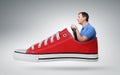 Funny man car driver with a wheel in red sneaker Royalty Free Stock Photo