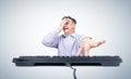 Funny man in casual clothes scared while making a facepalm and presses a key on a computer keyboard, on light background Royalty Free Stock Photo