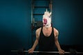 Funny man in comical mask doing sport exercise. Unusual guy pump up iron Royalty Free Stock Photo