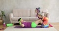 Funny man is doing abs exercises crunches at home with wife, fitness humor.