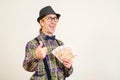 Funny man with a fan of money on white background. Man gesturing thumb up. Successful guy with cash money Royalty Free Stock Photo