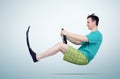 Funny man in flippers and shorts with a steering wheel. Concept of going on vacation Royalty Free Stock Photo