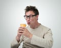 Funny man in glasses drink through a straw