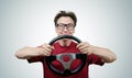 Funny man in glasses with a steering wheel, car drive concept Royalty Free Stock Photo