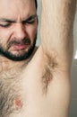 Funny man having bad smell from armpit Royalty Free Stock Photo