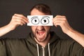 Funny man looking with hand drawn paper eyes Royalty Free Stock Photo
