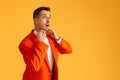 funny man in orange jacket on orange background. Royalty Free Stock Photo
