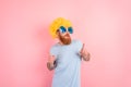 Funny man with peruke and sunglasses dances Royalty Free Stock Photo