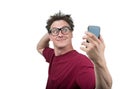 Funny man photographing himself on a smartphone
