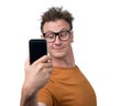 Funny man photographing himself on a smartphone