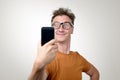 Funny man photographing himself on a smartphone