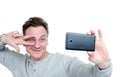 Funny man photographing himself on a smartphone