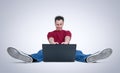 Funny man playing games sitting on the floor in front of a laptop Royalty Free Stock Photo