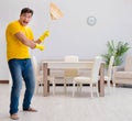 Funny man playing virtual guitar with broom