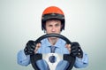 Funny man in a red helmet with steering wheel, car driver concept