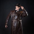 Funny man in a ridiculous leather coat and a top hat, Royalty Free Stock Photo