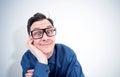 Funny man in a shirt and glasses props his head with his hand in an attentive listener pose. I am listening really carefully. Royalty Free Stock Photo