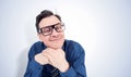 Funny man in a shirt and glasses props his head with his hand in an attentive listener pose. I am listening really carefully