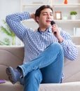 Funny man singing songs in karaoke at home Royalty Free Stock Photo