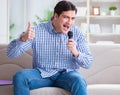 Funny man singing songs in karaoke at home Royalty Free Stock Photo