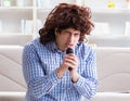 Funny man singing songs in karaoke at home Royalty Free Stock Photo