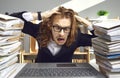 Funny man sitting at office desk with computer stressed by crazy load of paperwork Royalty Free Stock Photo