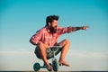 Funny man on small bicycle. Eccentric guy riding a bike. Royalty Free Stock Photo