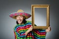 The funny man with sombrero and picture frame Royalty Free Stock Photo