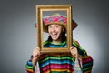 The funny man with sombrero and picture frame Royalty Free Stock Photo