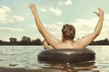 Retro man in summer lake have fun with inner tube Royalty Free Stock Photo