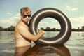 Retro man in summer lake have fun with inner tube Royalty Free Stock Photo