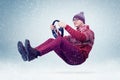 Funny man in sweater, scarf and hat, driving car with the steering wheel. Winter, snow, blizzard Royalty Free Stock Photo