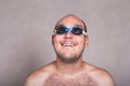 Funny man in swimming goggles daydreaming and looking up