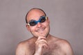 Funny man in swimming goggles daydreaming and looking at you