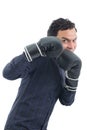 worker wears boxing gloves and makes defense position. The person is wearing dark blue social shirt. Isolated.. Royalty Free Stock Photo