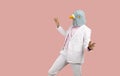 Funny man in a weird pigeon mask dancing and having fun at a crazy fancy dress party Royalty Free Stock Photo