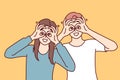 Funny man and woman make binoculars from fingers and look at screen smiling to cheer friends. Royalty Free Stock Photo