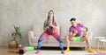 Funny man and woman newcomers in sport are doing fitness exercises at home.