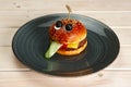 Funny meal for children. Burger in sahpe of face with pulled out tongue