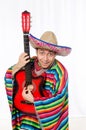 Funny mexican with guitar isolated on white