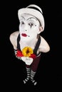 Funny mime in white hat with a bouquet of flowers Royalty Free Stock Photo