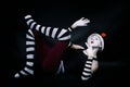 Funny mime in white hat lying on floor Royalty Free Stock Photo