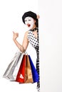 Funny mime woman holding shopping bags.