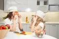 Funny mom and daughter holding pepper slices as glasses. Royalty Free Stock Photo