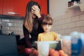 Mother Supervising Little Girl Baking a Cake Together Royalty Free Stock Photo