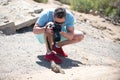 Funny moments in nature. Man photographer with a large professional camera photograph funny squirrel. Portrait of