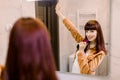Funny morning routine at home. Portrait of beautiful young Caucasian woman having fun in the bathroom looking at the Royalty Free Stock Photo