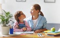 funny mother and child daughter doing homework writing and reading Royalty Free Stock Photo